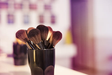 makeup brush on vase on table top thumbnail