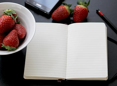white notebook near strawberries thumbnail