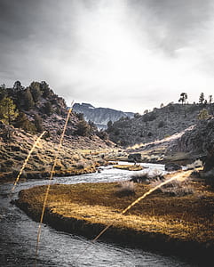 body of water between cliffs thumbnail