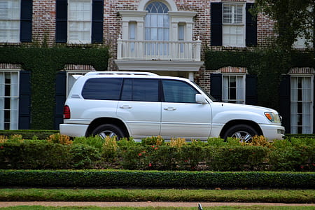 white Toyota Land Cruiser SUV parked near house thumbnail