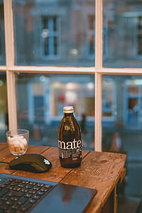 mate labeled bottle on table beside Steelseries mouse thumbnail