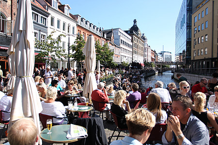people sitting on chairs near canal thumbnail