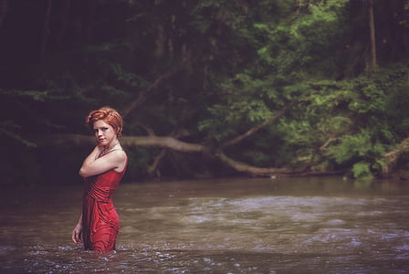 woman in body of water wearing red dress thumbnail