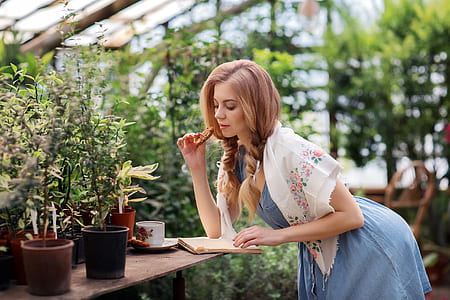 woman reading book while eating food thumbnail