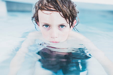 toddler in body of water close-up photo thumbnail