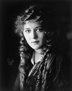 grayscale photography of woman with curly hair thumbnail