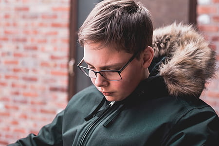 man in green parka jacket wearing eyeglasses thumbnail