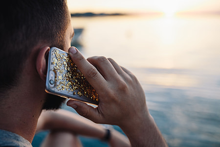 Mobile phone in man's hands near the sea thumbnail