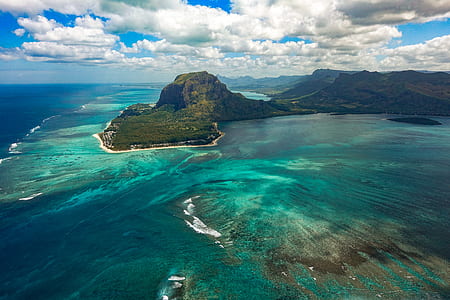 green island surrounded by body of water thumbnail
