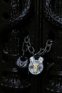gray padlock with chain in black gate thumbnail