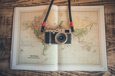 black and silver camera on top of world map thumbnail