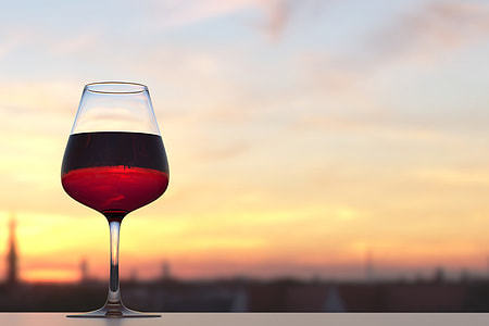 Glass of red wine at sunset thumbnail