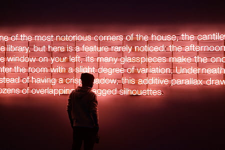 man reading neon light signage thumbnail