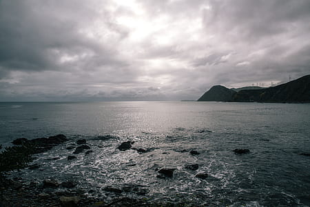 body of water under cloudy sky thumbnail