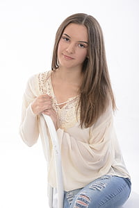 woman in beige long-sleeved top and blue distressed jeans thumbnail
