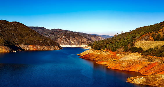 body of water beside mountain thumbnail