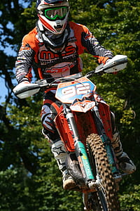 rider riding orange motocross dirt bike thumbnail