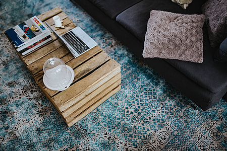 Designer living room interior with a wooden box table and a light blue carpet thumbnail