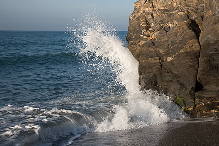 seawaves smashing through rock formation thumbnail