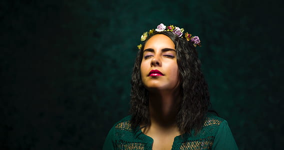 woman in green top with floral headband thumbnail