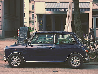blue coupe parked near Cafe building at daytime thumbnail