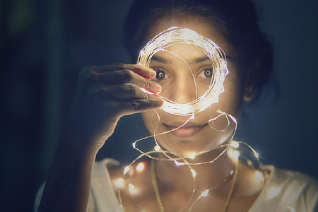 woman holding string light thumbnail