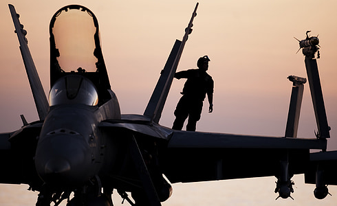 silhouette photography of man on fighter plane thumbnail