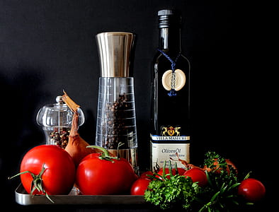 Tomatoes Beside Shakers and Olive Oil Bottle thumbnail