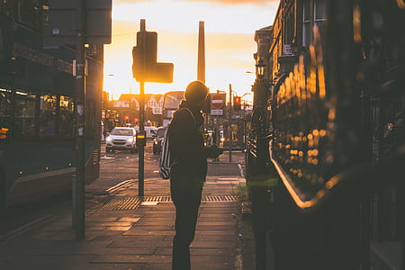 man standing facing building thumbnail