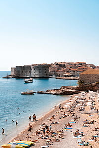 people lying near seashore thumbnail
