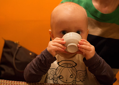 child holding ceramic bowl thumbnail