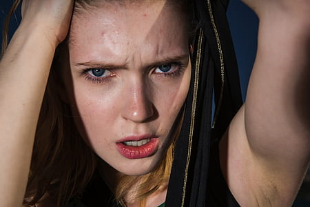 woman wearing black tank top while holding her head thumbnail