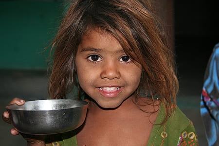 girl in green top holding bowl thumbnail