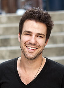 man's wearing black v-neck top thumbnail