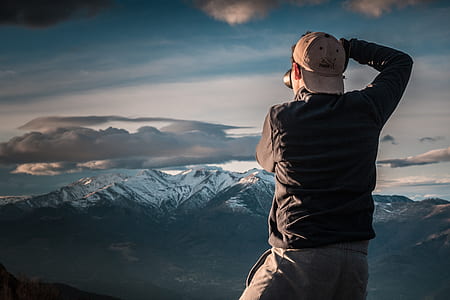 man taking photo of mountain thumbnail