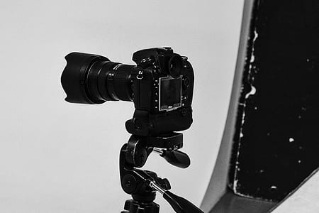 black DSLR camer on white surface thumbnail