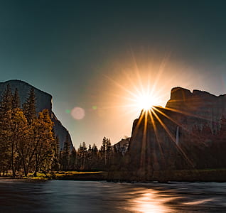 landscape photo of sun behind mountain thumbnail