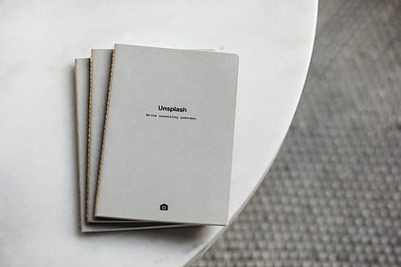 three gray books on white table thumbnail