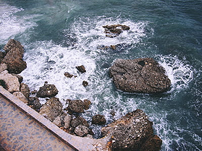 aerial photography of boulders on shore thumbnail