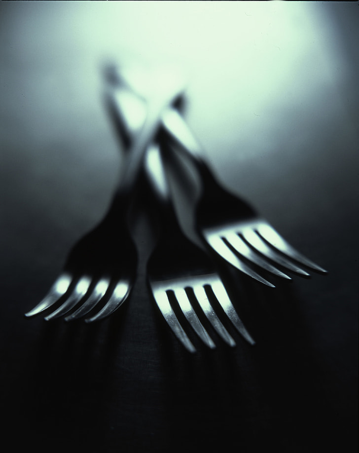 three stainless steel forks