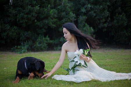 woman wearing tube dress beside Rottweiler dog thumbnail