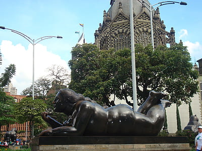 woman laying down statue near light post thumbnail