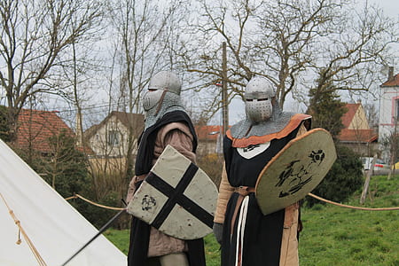 two knights standing near trees thumbnail