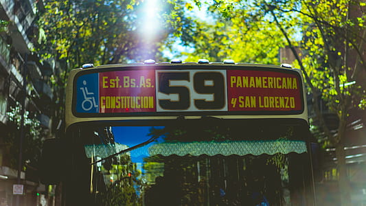 beige and multicolored bus with signage thumbnail