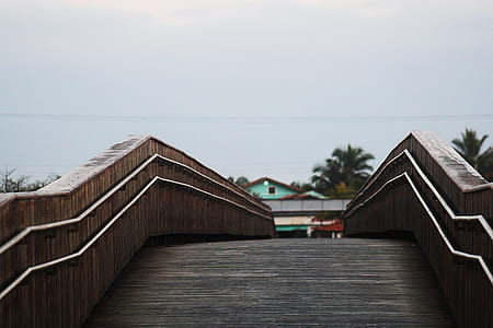 brown wooden bridge near house thumbnail