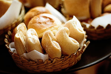 baked breads in round brown wicker bowl thumbnail