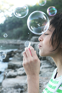 selective focus photography of woman surrounded by bubbles thumbnail
