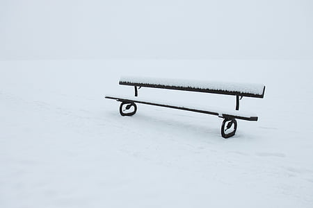 black bench covered in snow thumbnail