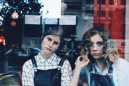 photo of two woman looking on window thumbnail