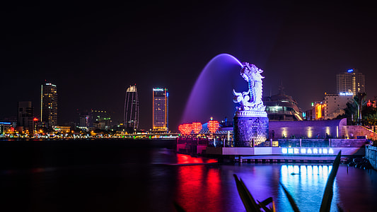 dragon fountain near the city during night thumbnail